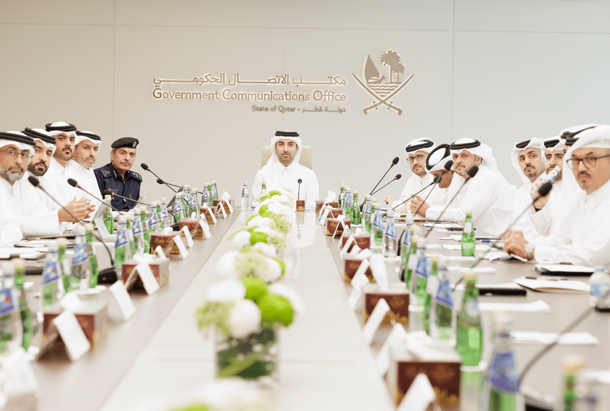 Officials attend a joint newsroom meeting at the Government Communications Office in Qatar to align communication efforts